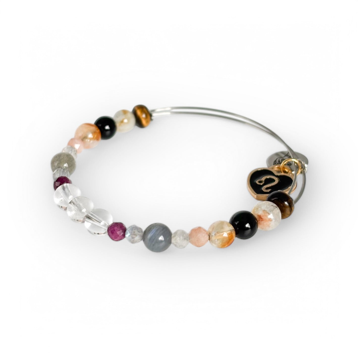 Close-up of Leo Crystal Charm Bracelet with a black charm, showcasing its deep, fiery gemstone hues.