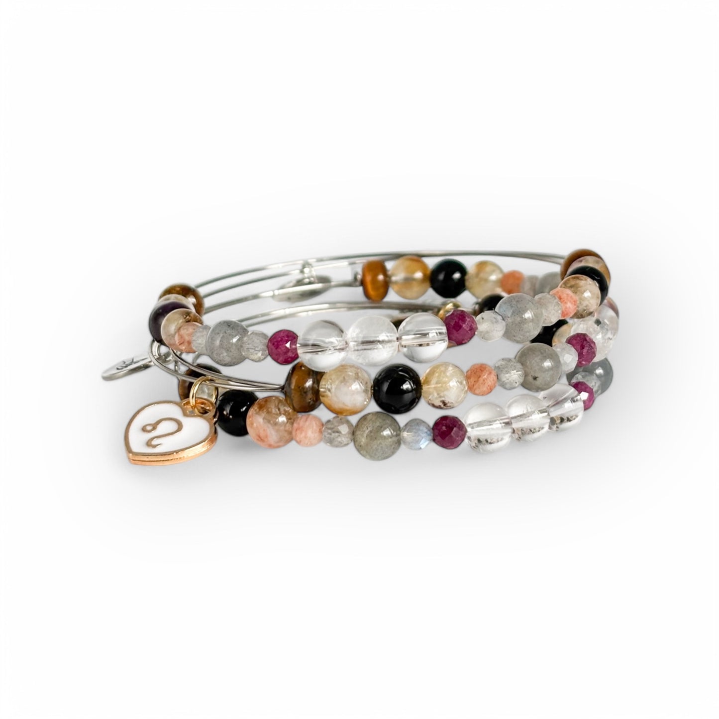 Leo Crystal Charm Bracelet with a white charm stacked with other crystal bracelets for a powerful, layered look.