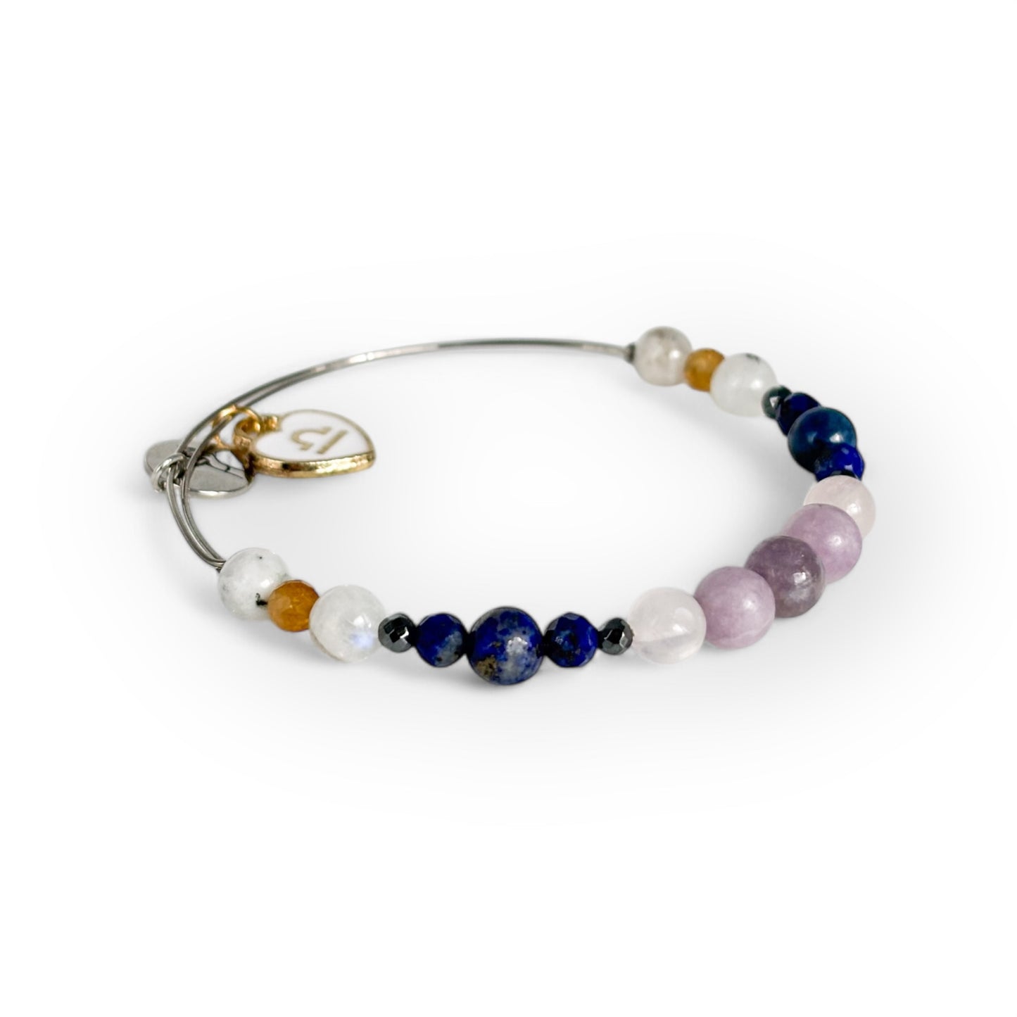 Close-up of Libra Crystal Charm Bracelet with a white charm, showcasing its soft pink, blue, and golden gemstone beads.