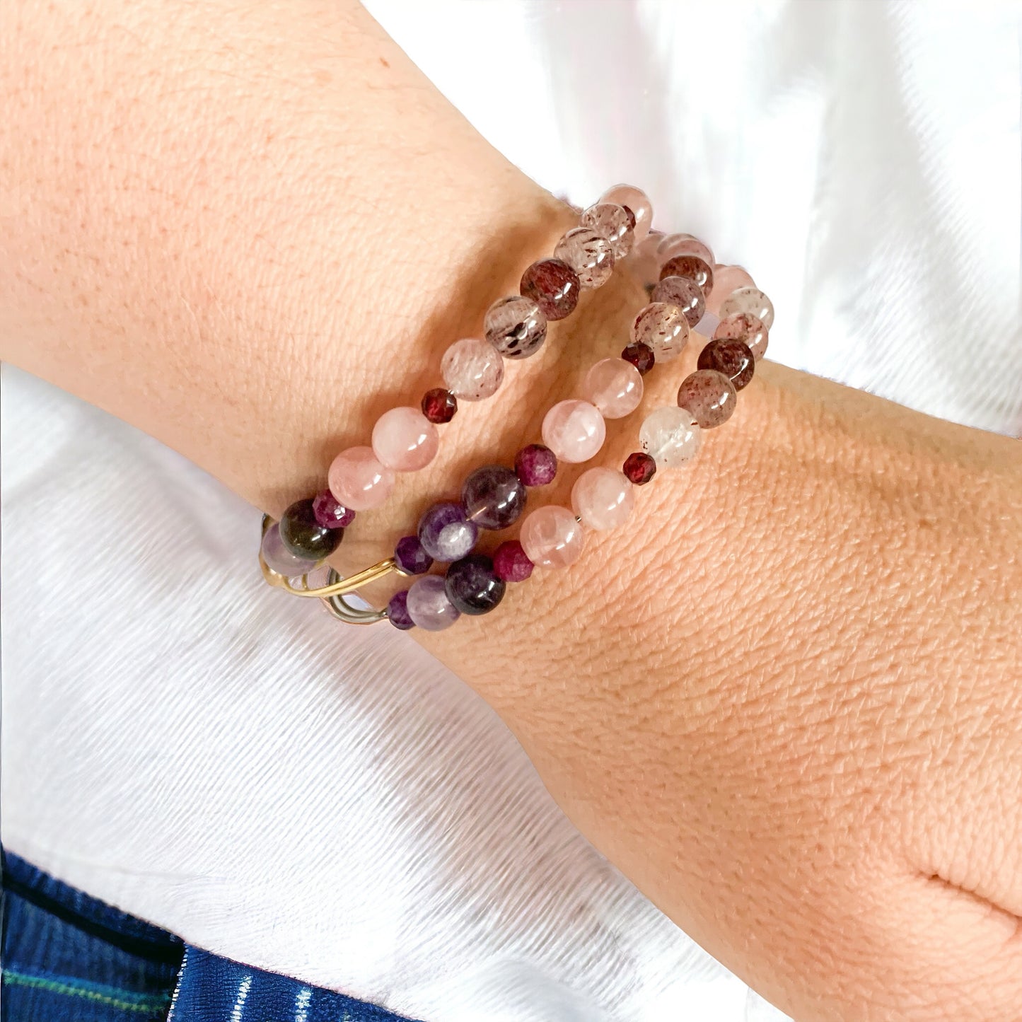 Stack of Love Crystal Bracelets with strawberry quartz, amethyst, and rose quartz