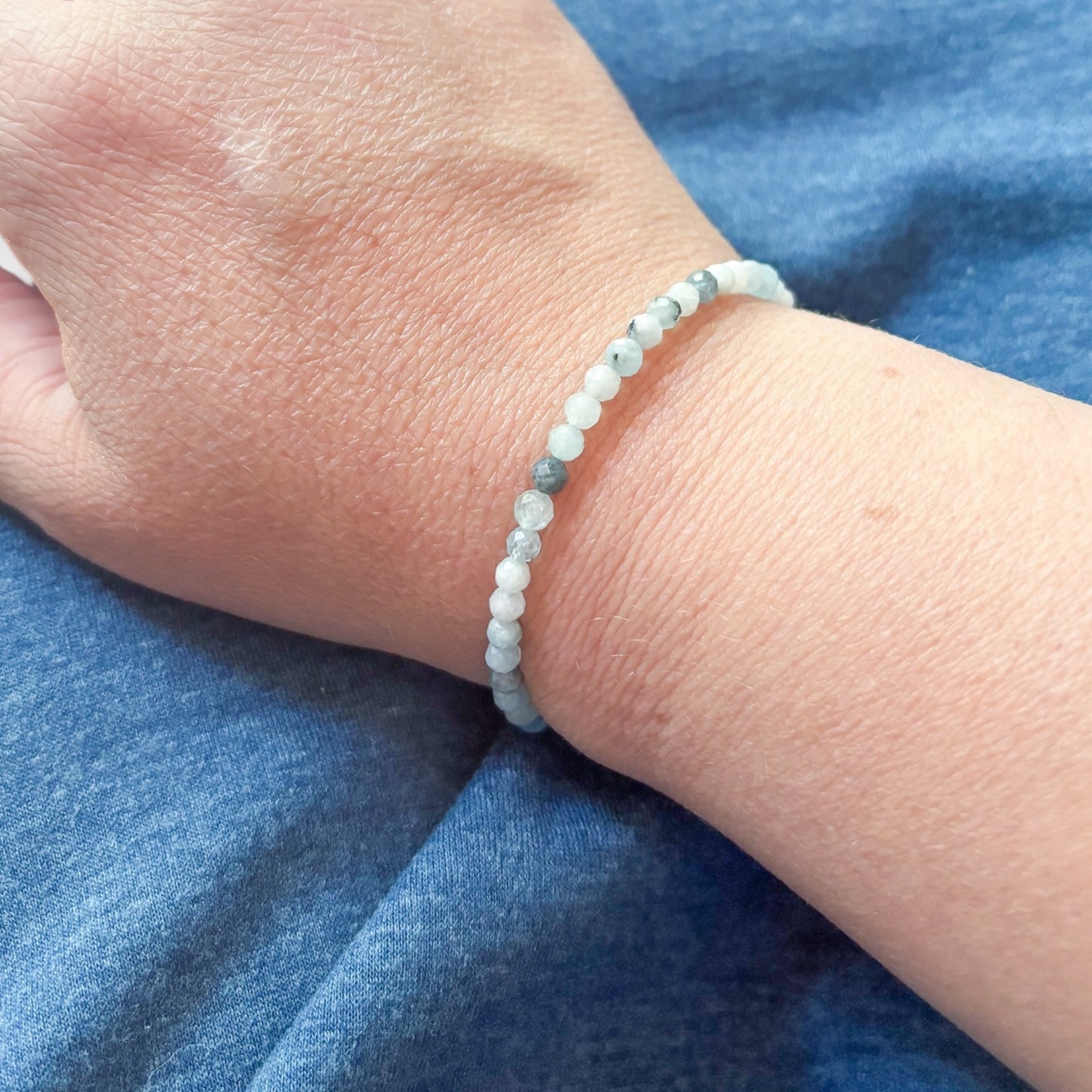 Model wearing blue Aquamarine wrap bracelet to show size and micro-faceted beads.