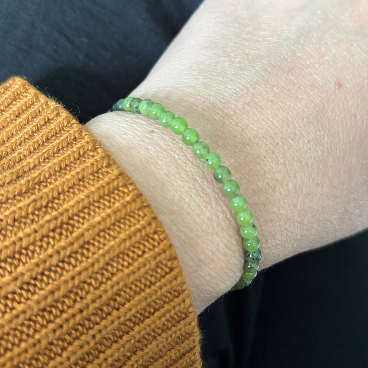 Nephrite Jade bracelet wrapped on wrist with neutral-toned outfit