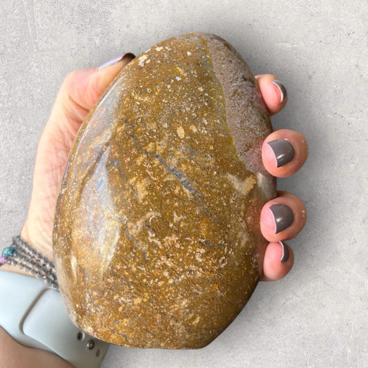 Ocean Jasper freeform held in hand to show size and smooth texture