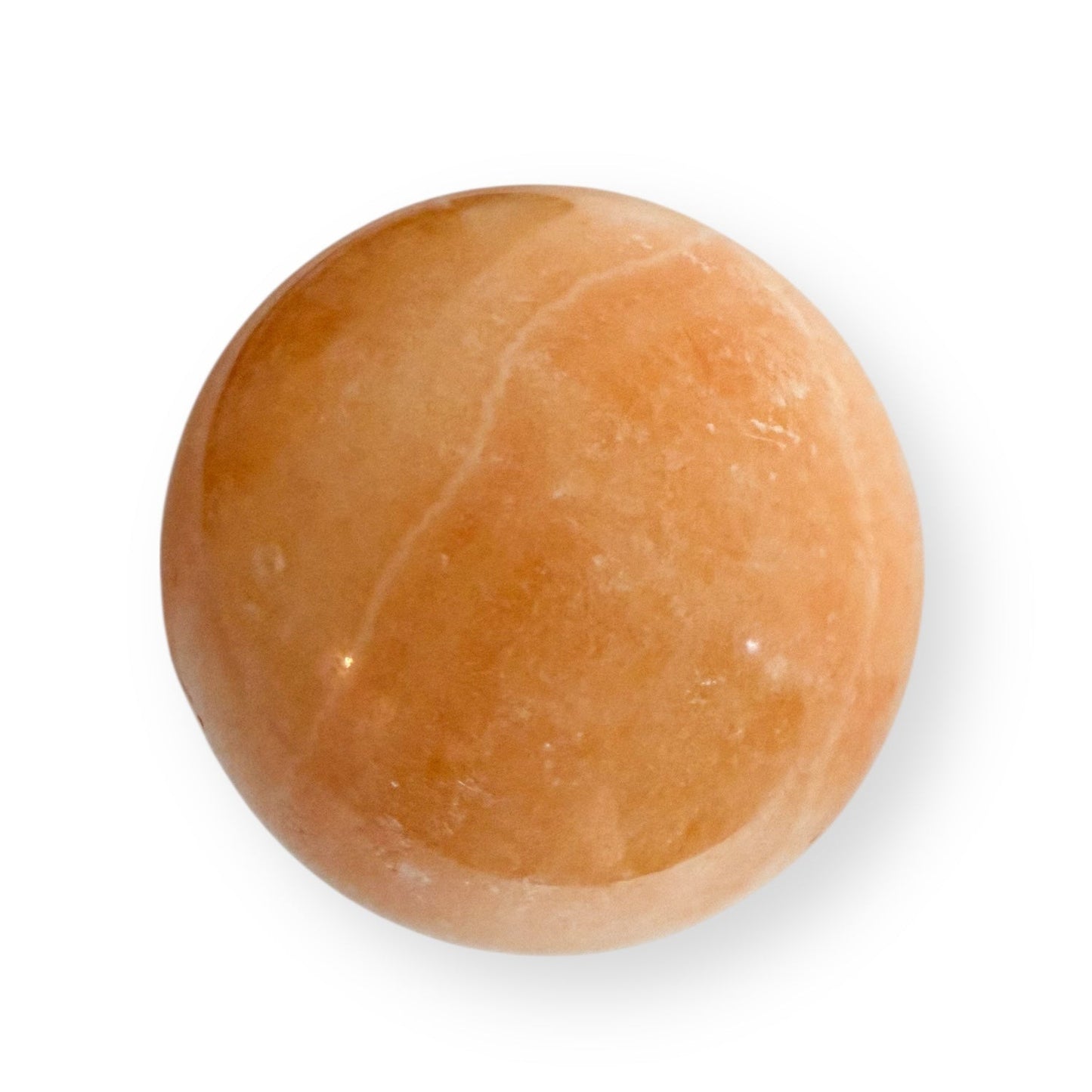 Closeup of polished Orange Calcite crystal sphere