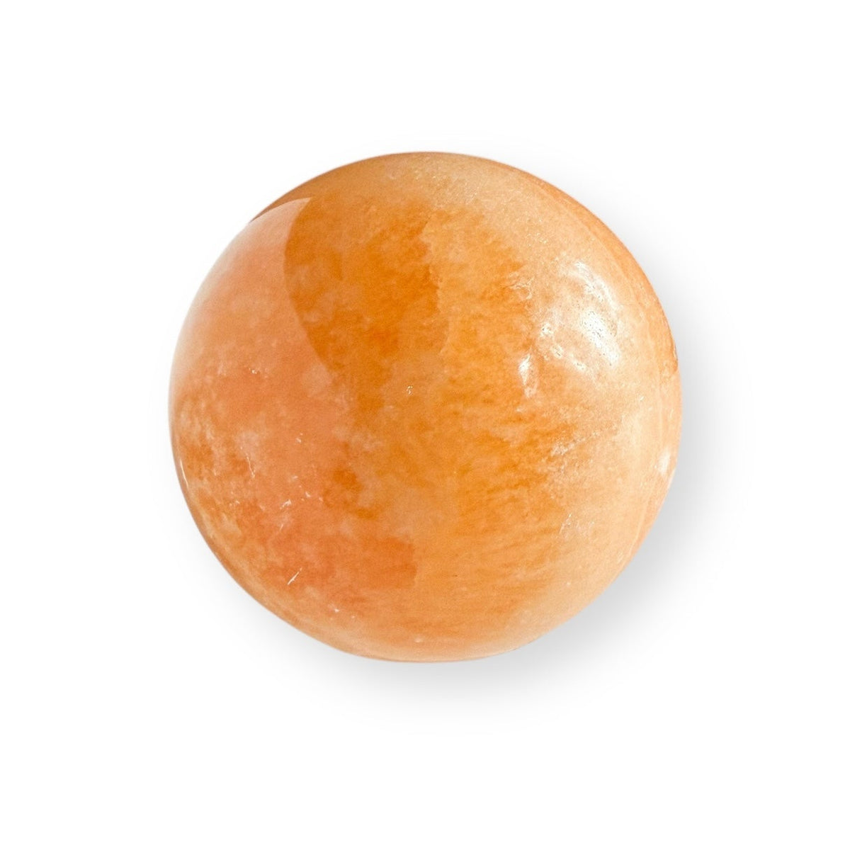 Orange Calcite sphere showing natural color variations