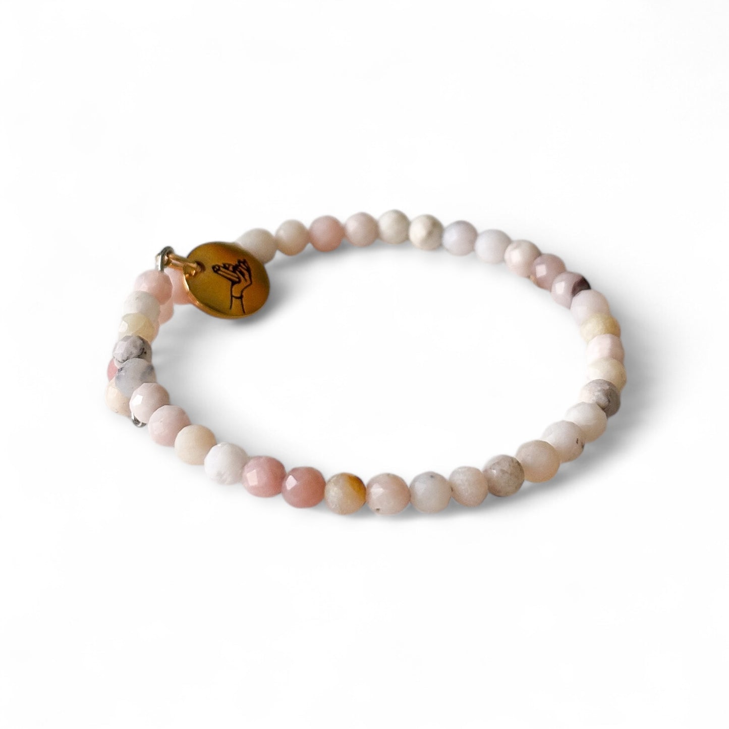 Close-up of Pink Opal micro-faceted beads with delicate sparkle