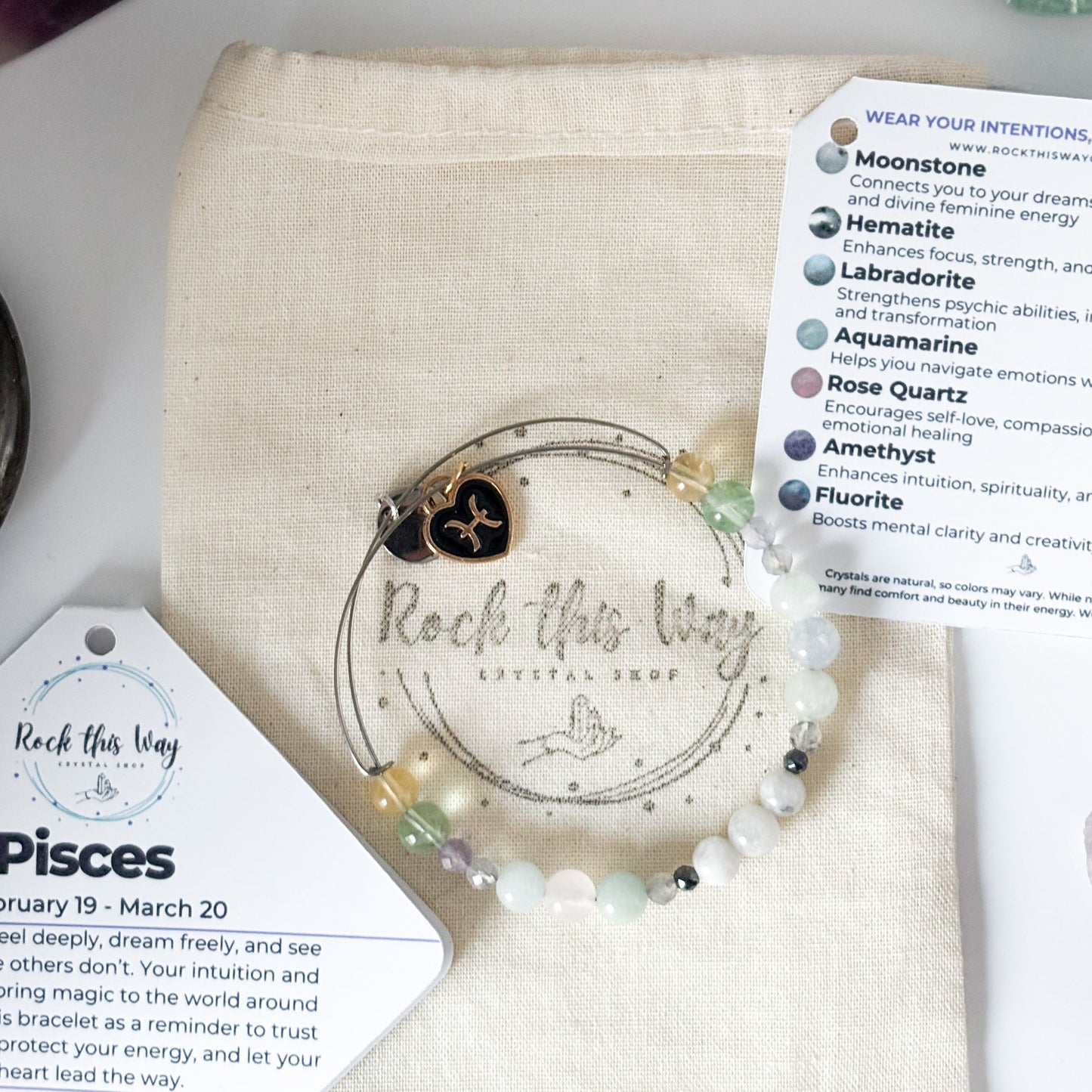 Pisces Crystal Charm Bracelet with a black charm displayed in Rock This Way Crystal Shop packaging, perfect for gifting.