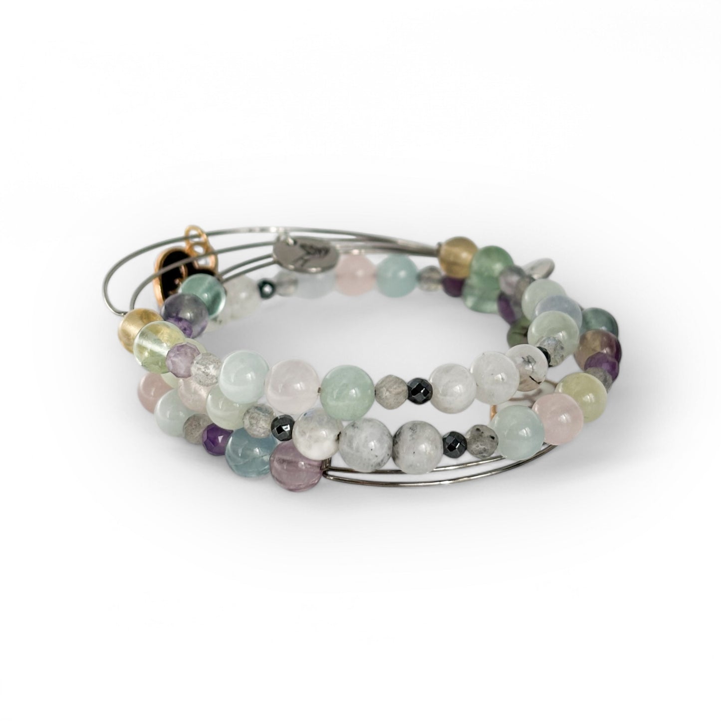 Pisces Crystal Charm Bracelet with a black charm stacked with other bracelets for an elegant, layered look.