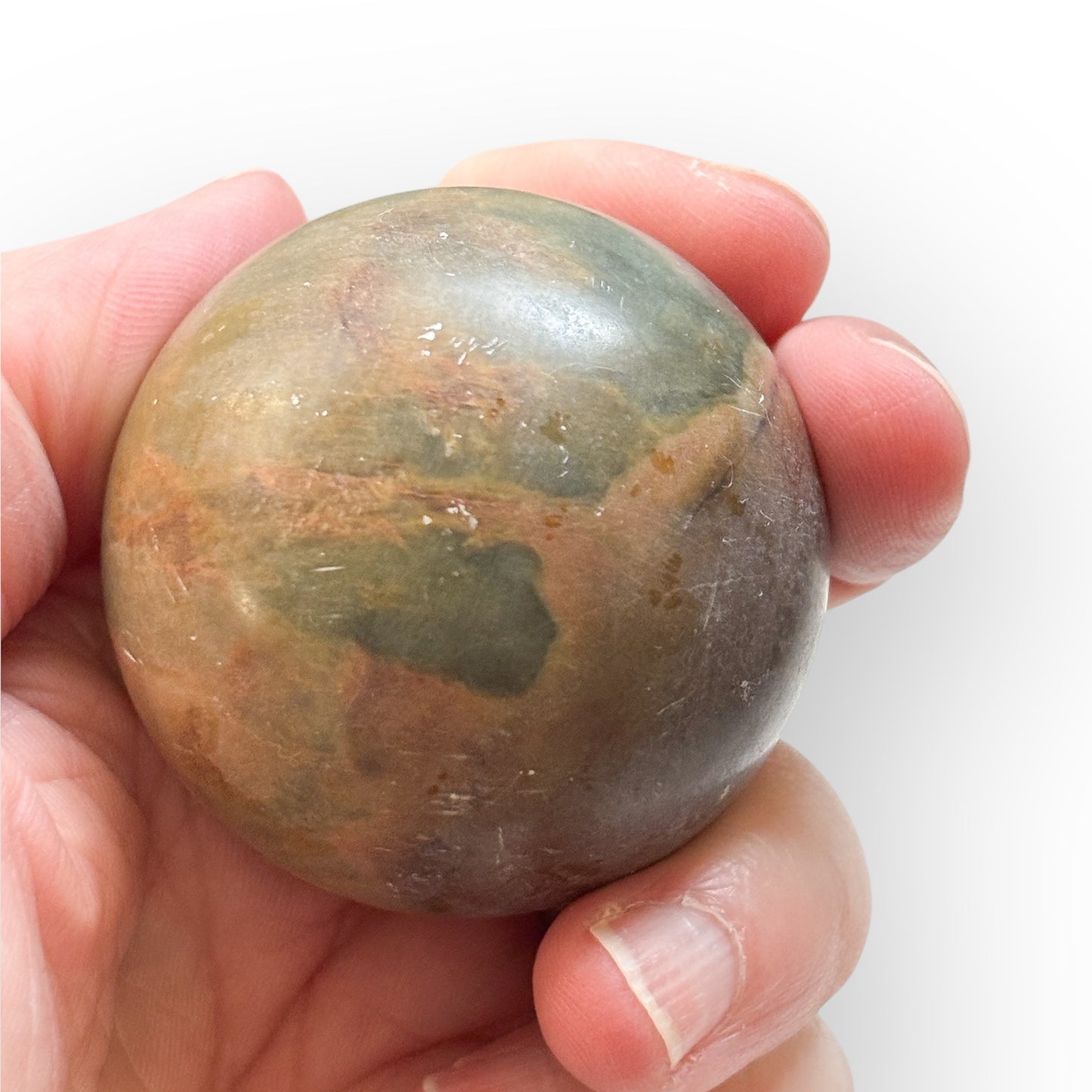 Matte Polychrome Jasper Sphere held in hand for size reference