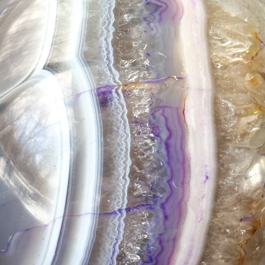 Close-up of druzy crystal core in Purple Agate Sphere with fine banding.