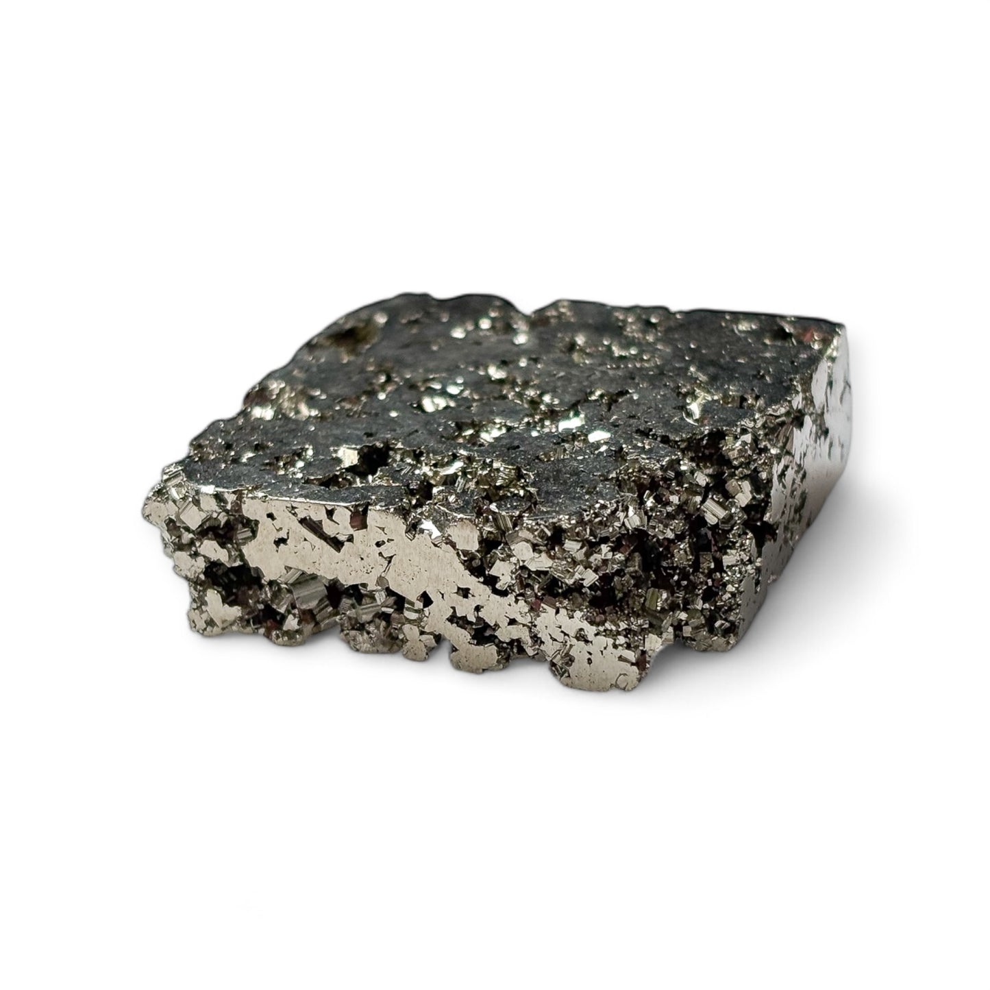 Closeup of pyrite cube’s reflective surface and textured slab