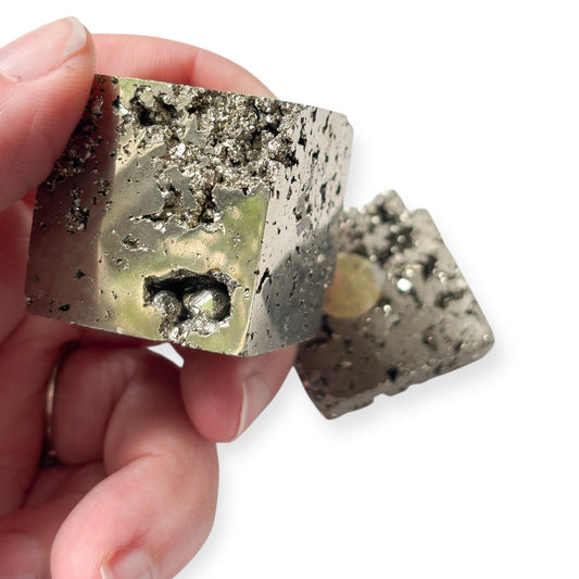Front view of polished pyrite cube on slab for grounding energy