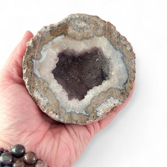 Quartz Geode held in hand for scale