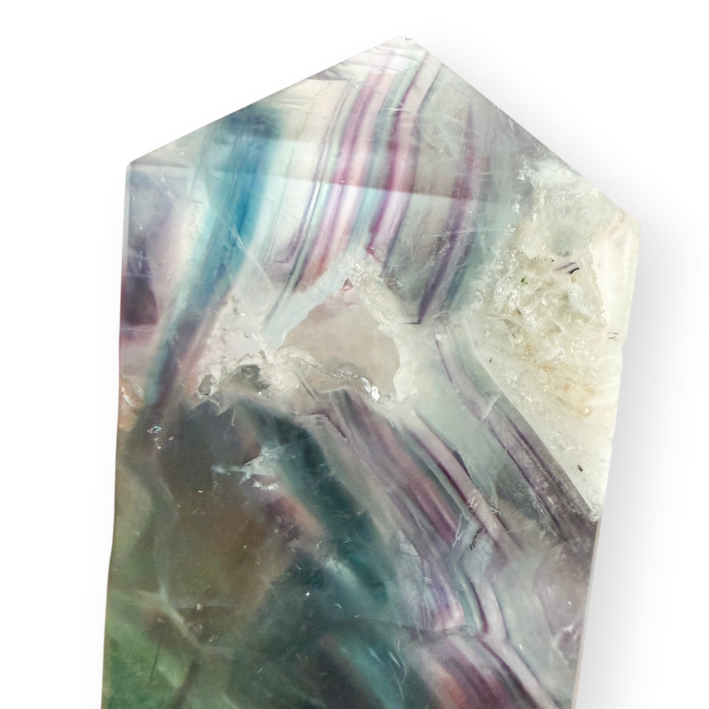 Close-up of a Rainbow Fluorite tower highlighting a natural druzy cavity, internal fractures, and colorful banding.
