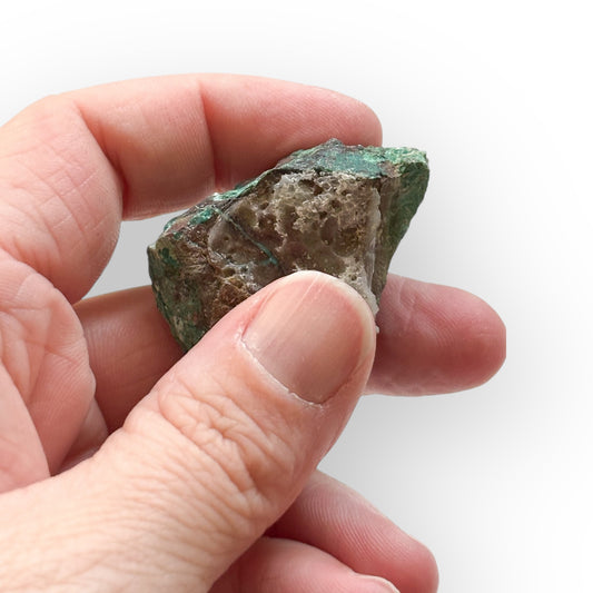 Hand holding Raw Malachite Crystal showing size and earthy detail