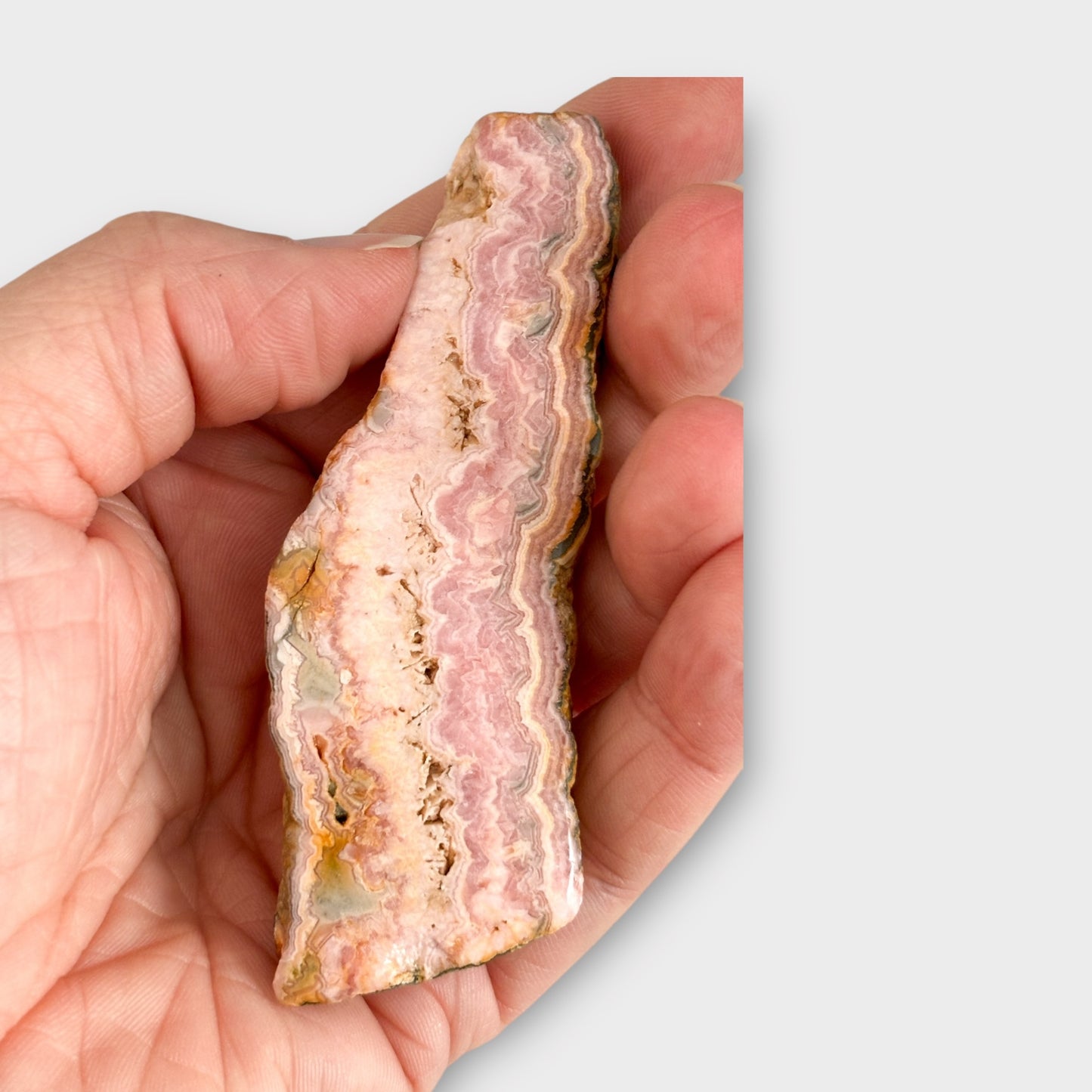 Back of Rhodochrosite slab with natural patterns and warm tones