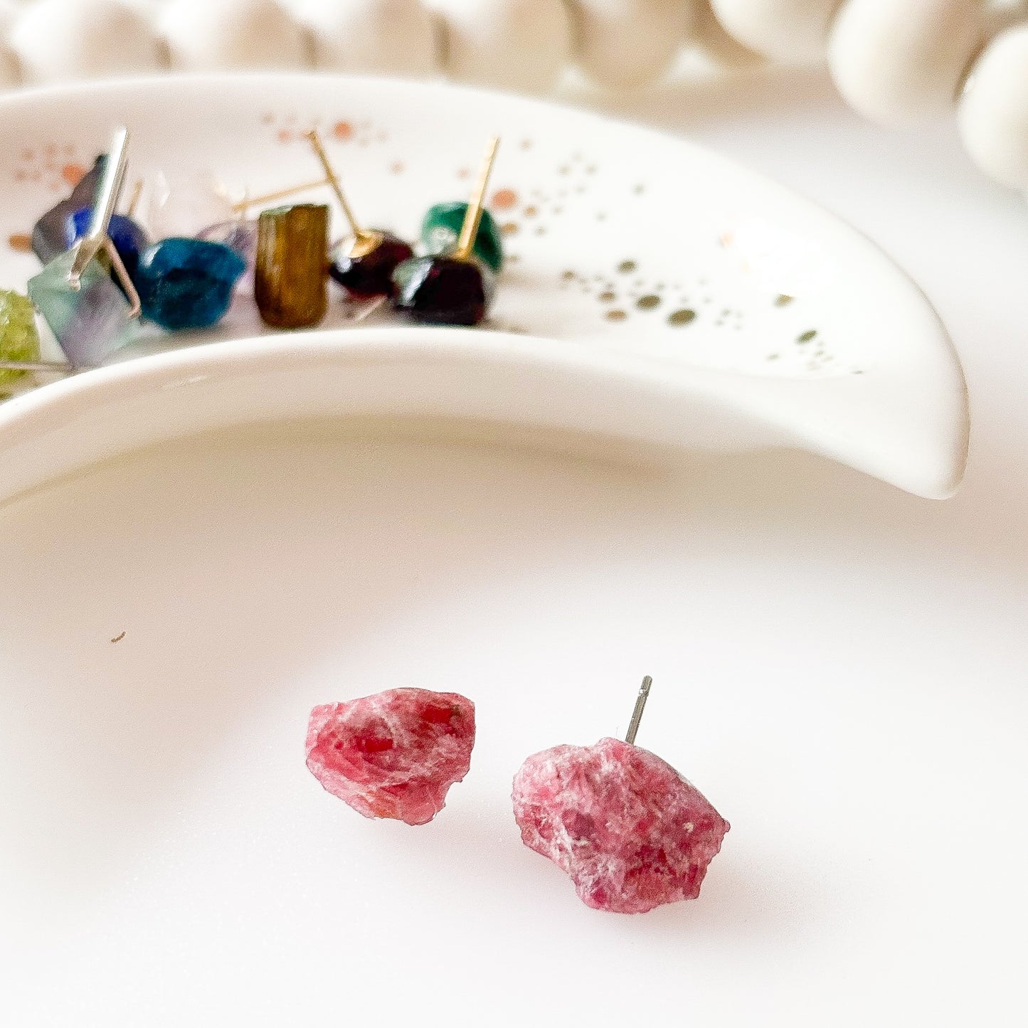 Natural rhodonite crystal earrings symbolizing confidence and compassion