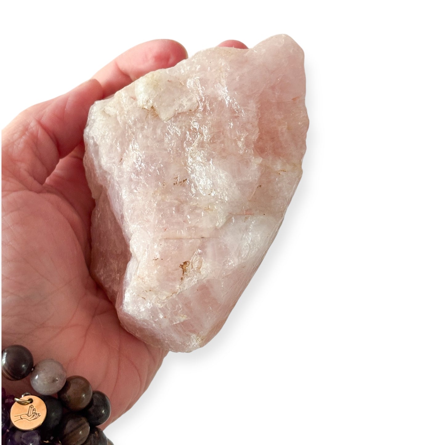 Hand holding large Rose Quartz rough to show scale and detail