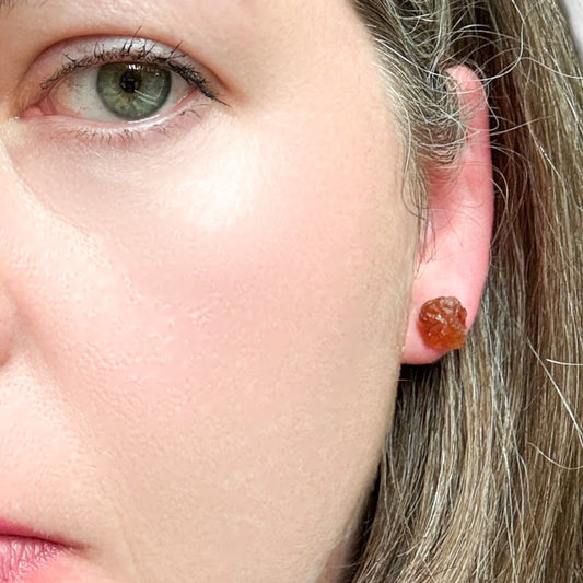 Front view of rough Ruby stud earrings on stainless steel hypoallergenic posts