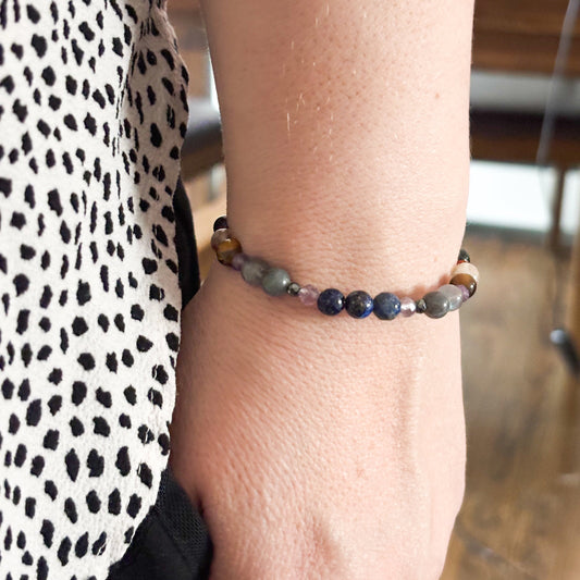 Sagittarius Crystal Charm Bracelet with a white charm worn on wrist, highlighting its flexible, comfortable fit and radiant crystals.