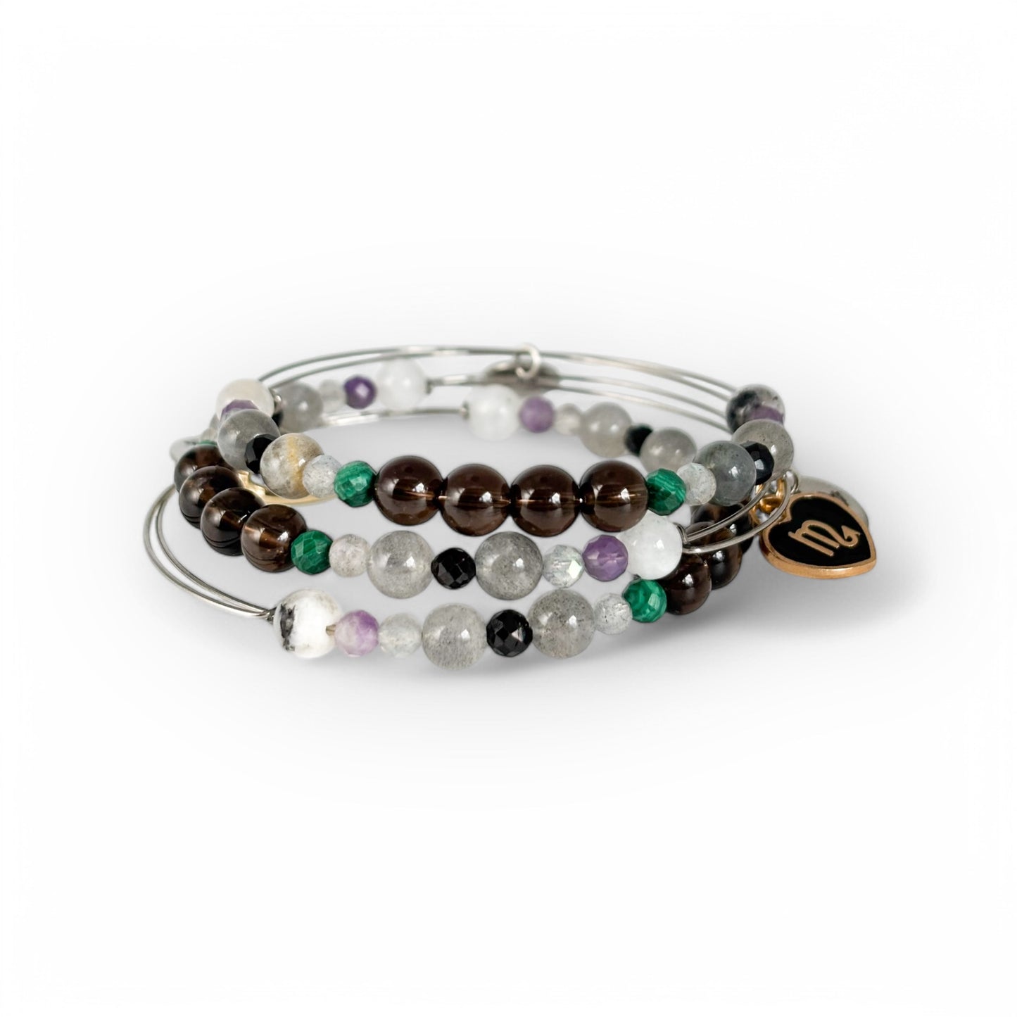 Scorpio Crystal Charm Bracelet with a white charm stacked with other bracelets for a bold, layered energy.