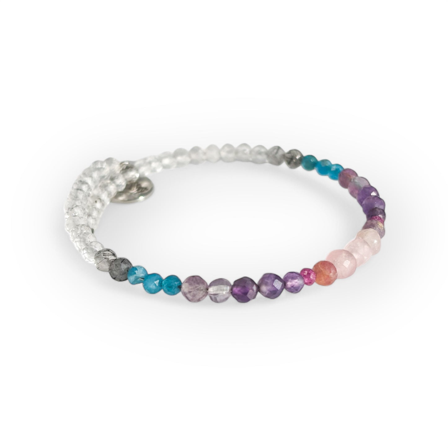 Close-up of faceted crystal beads including Rose Quartz, Amethyst, and Clear Quartz
