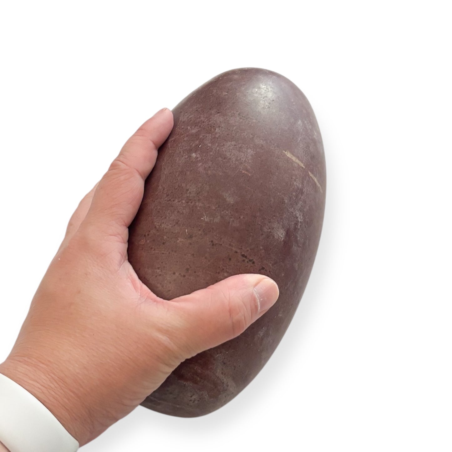 Close-up of the Shiva Lingam surface showing subtle color variations and earthy tones