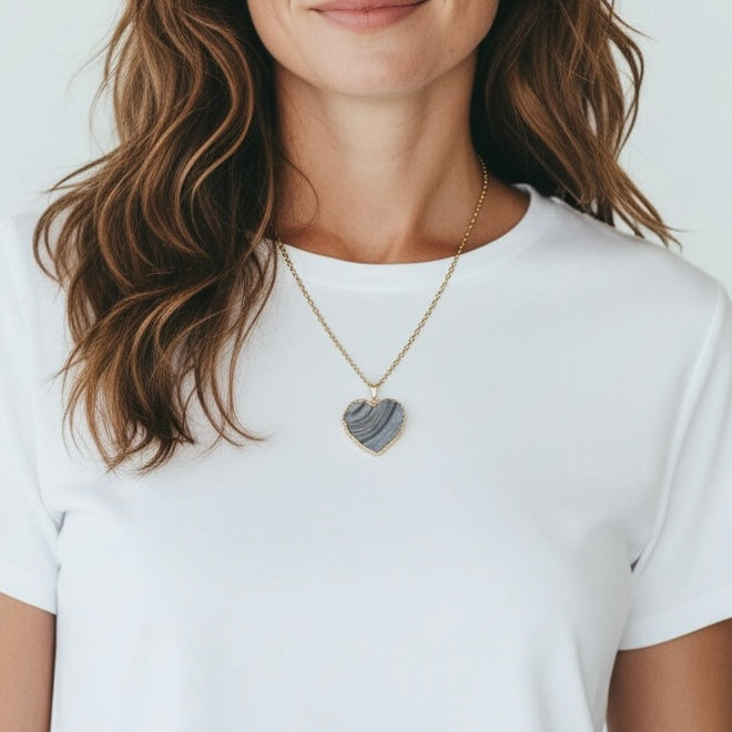 Modeled view of a silver plated heart drusy pendant necklace on a stainless steel chain, shown in an AI generated lifestyle image.