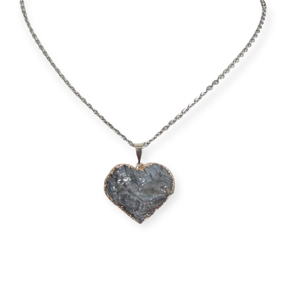 Silver plated heart drusy pendant necklace with gray crystal tones on a stainless steel chain, showing natural tarnish near the edges.
