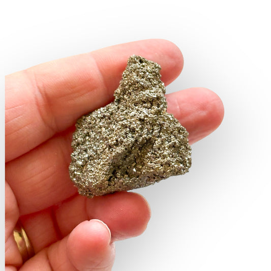 Small Pyrite Crystal Cluster resting in hand, showing scale and texture.
