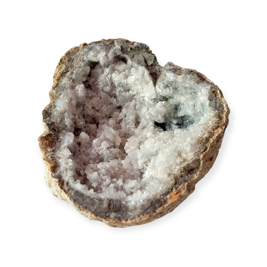 Sugar Quartz geode held in hand with sparkling white interior