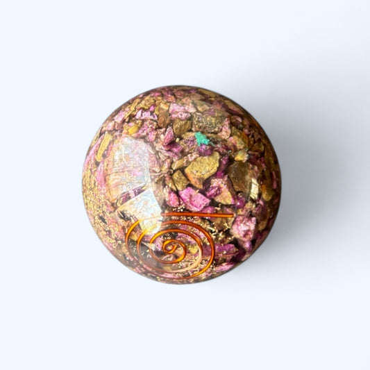 Close-up of Sugilite Orgone Sphere showing rich purple and gold crystal detail