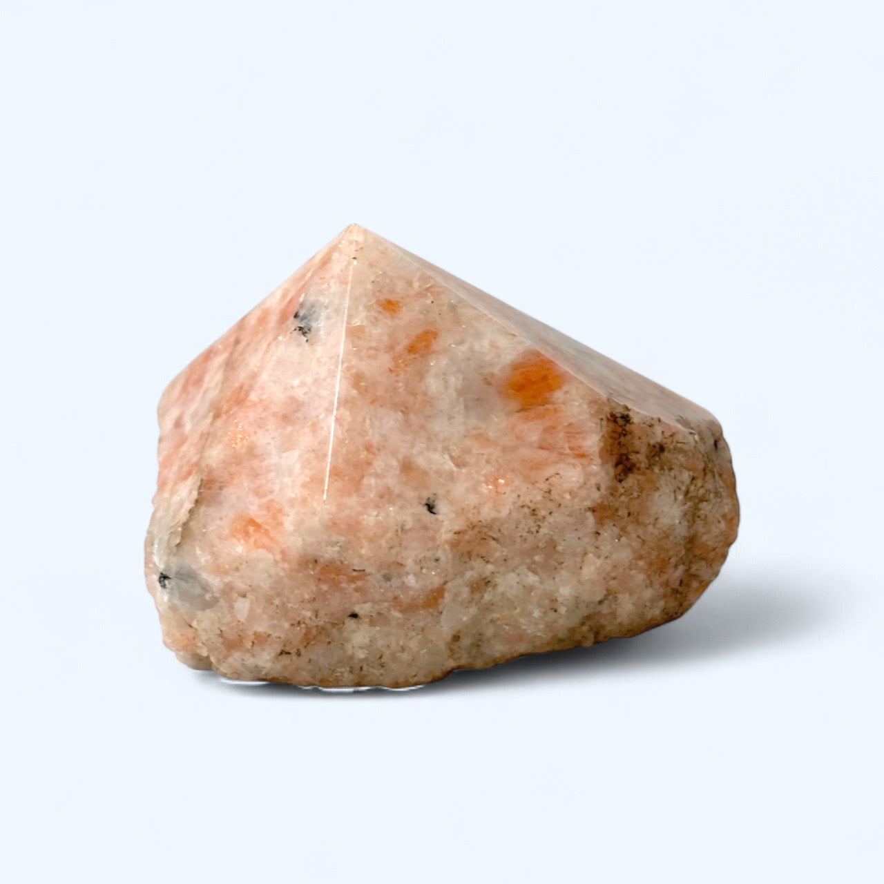 Sunstone, orange toned, top polished point on white background