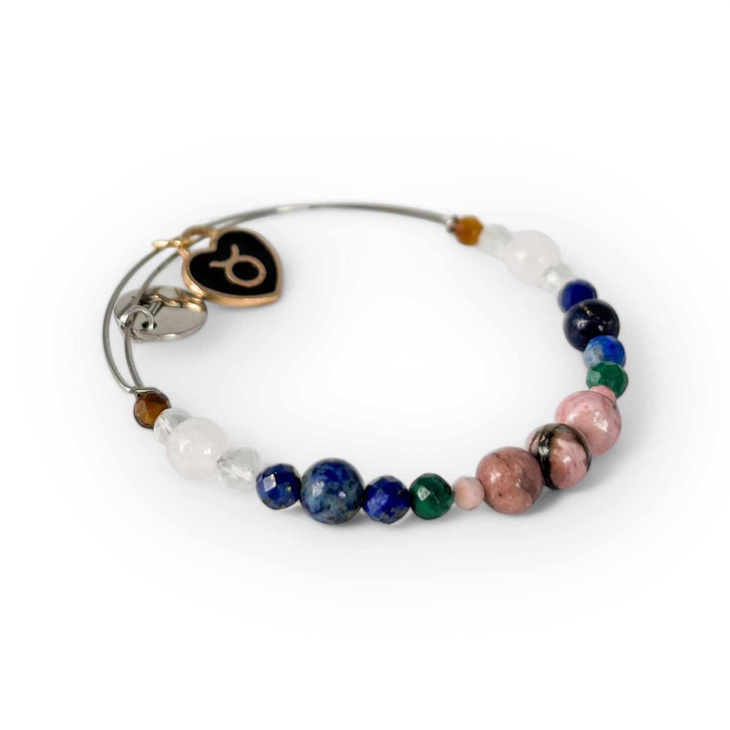 Close-up of Taurus Crystal Charm Bracelet with a black charm, highlighting its grounding, heart-healing stones.