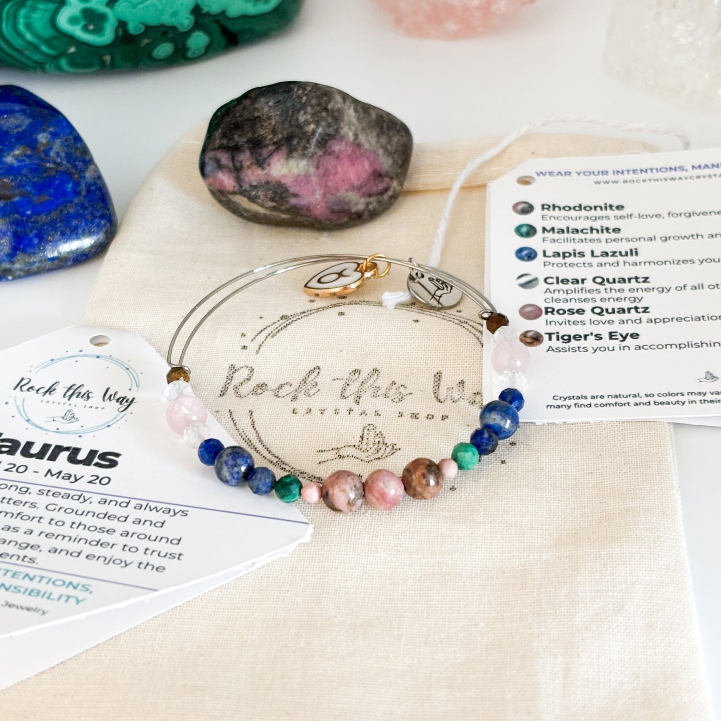Taurus Crystal Charm Bracelet with a white charm displayed in Rock This Way Crystal Shop packaging, ready for gifting.