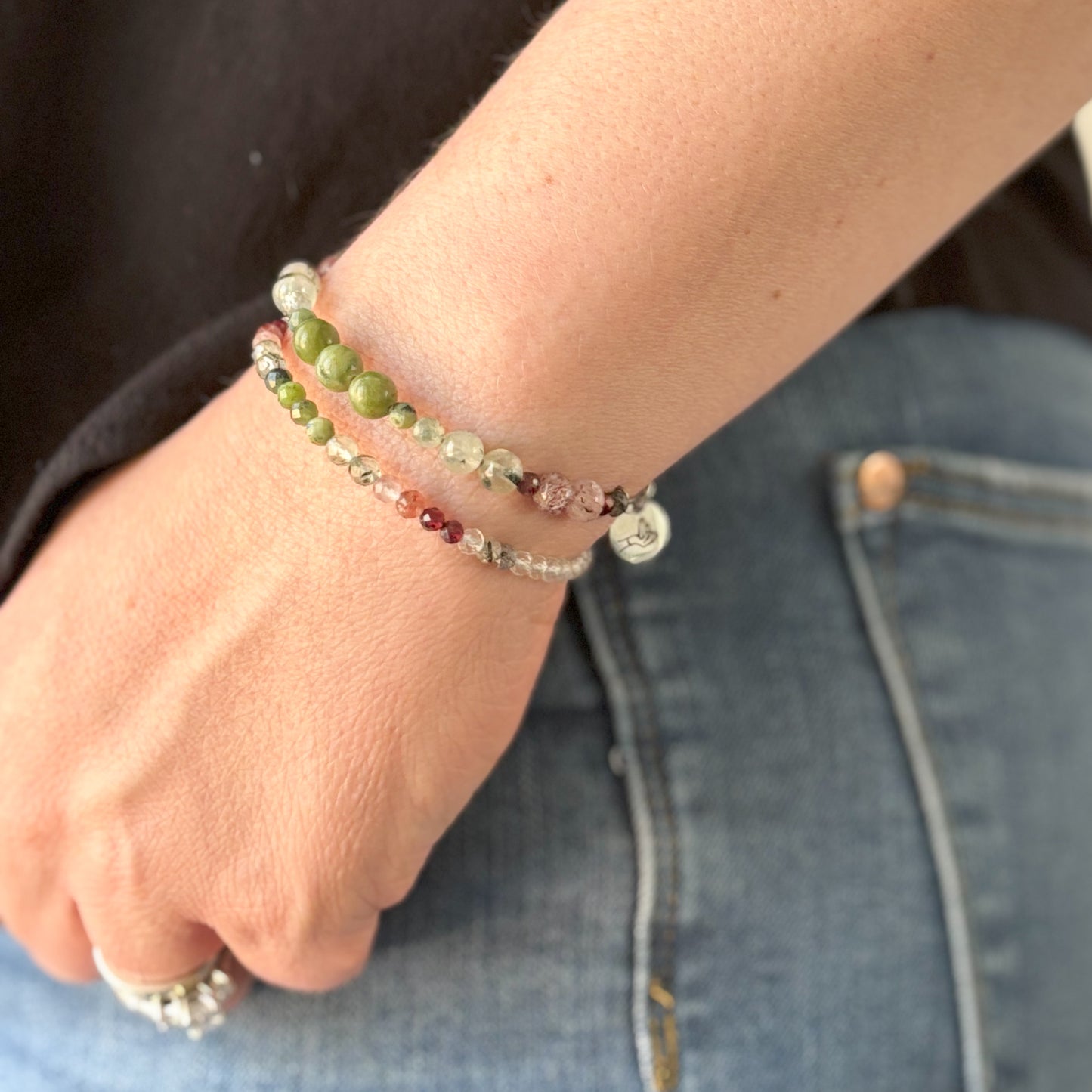 Tenacious Wrap Bracelet on wrist, showing earthy green and deep red crystal beads.