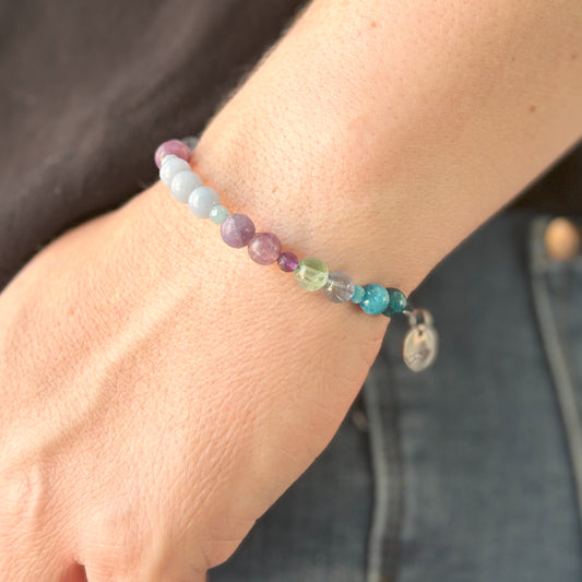 Bracelet styled on wrist with calming blue and lavender hues
