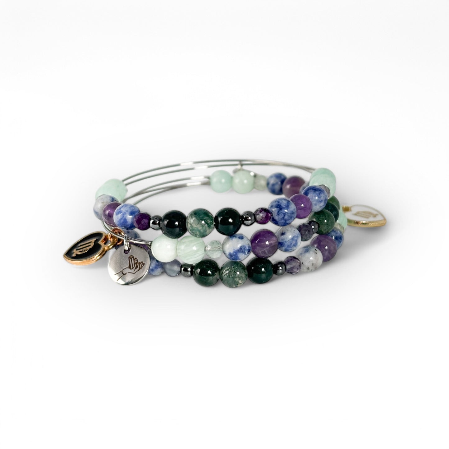 Virgo Crystal Charm Bracelet with a white charm stacked with other bracelets for a clean, structured, and balanced style.