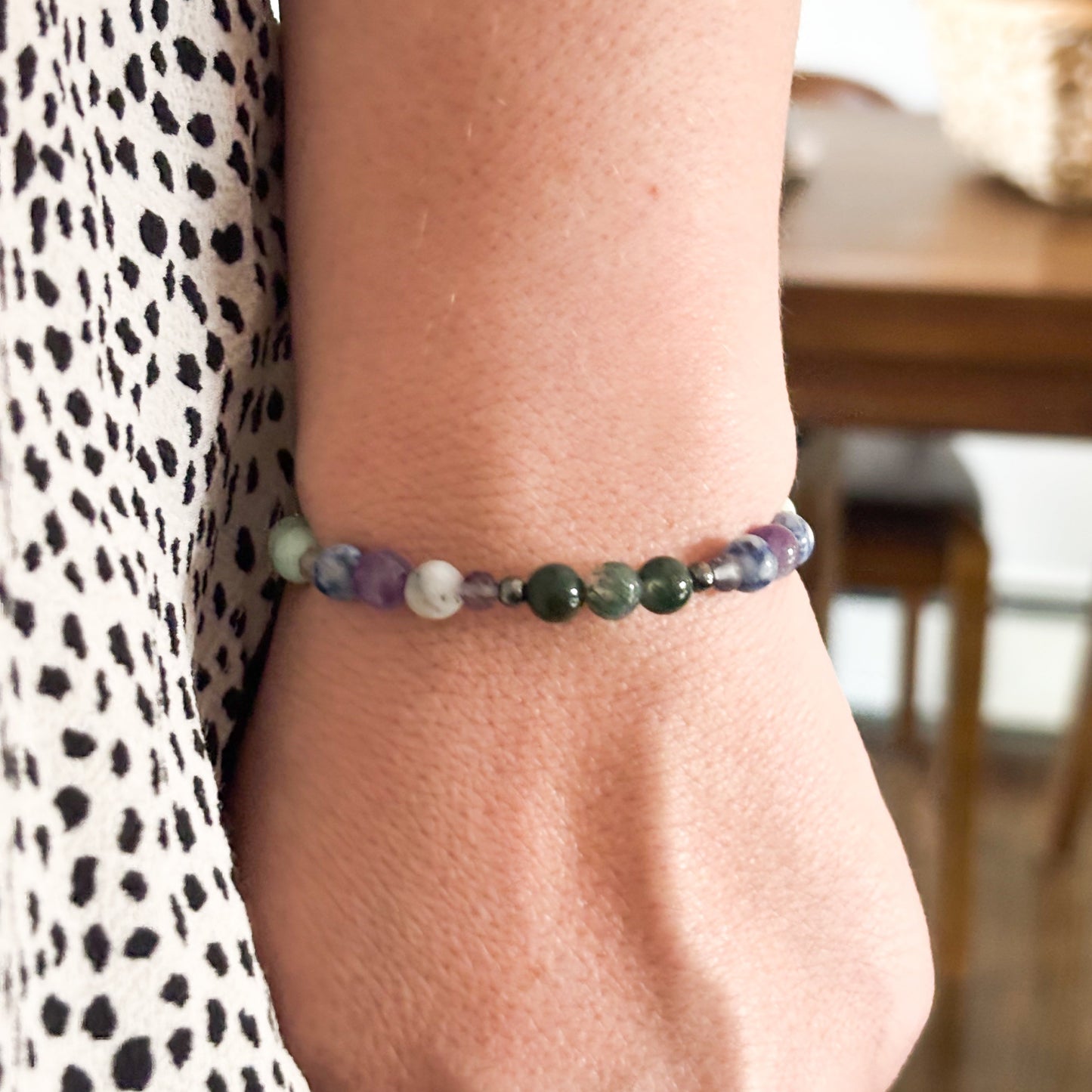 Virgo Crystal Charm Bracelet with a white charm worn on wrist, highlighting its lightweight and flexible fit.