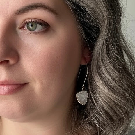 White squoval freeform drusy earrings with gold filled ear wires worn on ear, lightweight 2 inch drop with natural white crystal sparkle