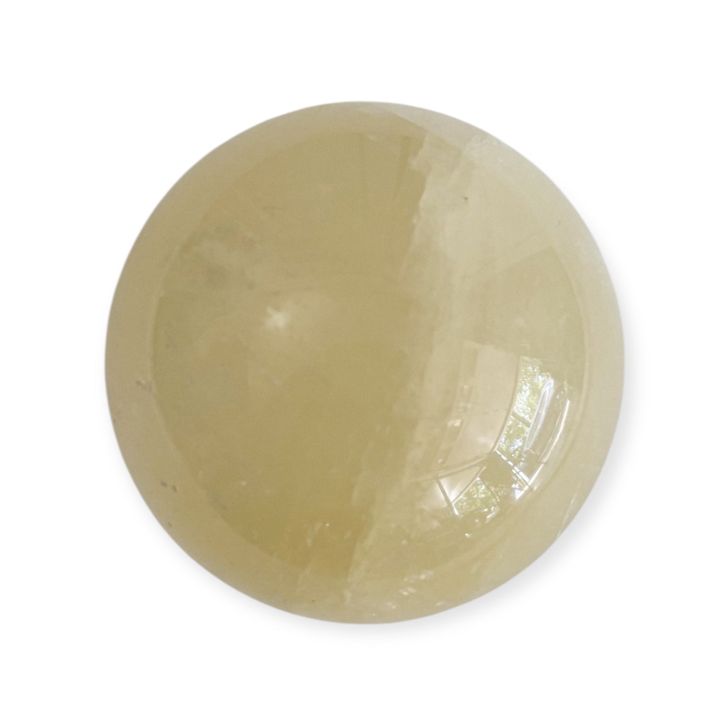 Light reflecting on smooth Yellow Calcite sphere