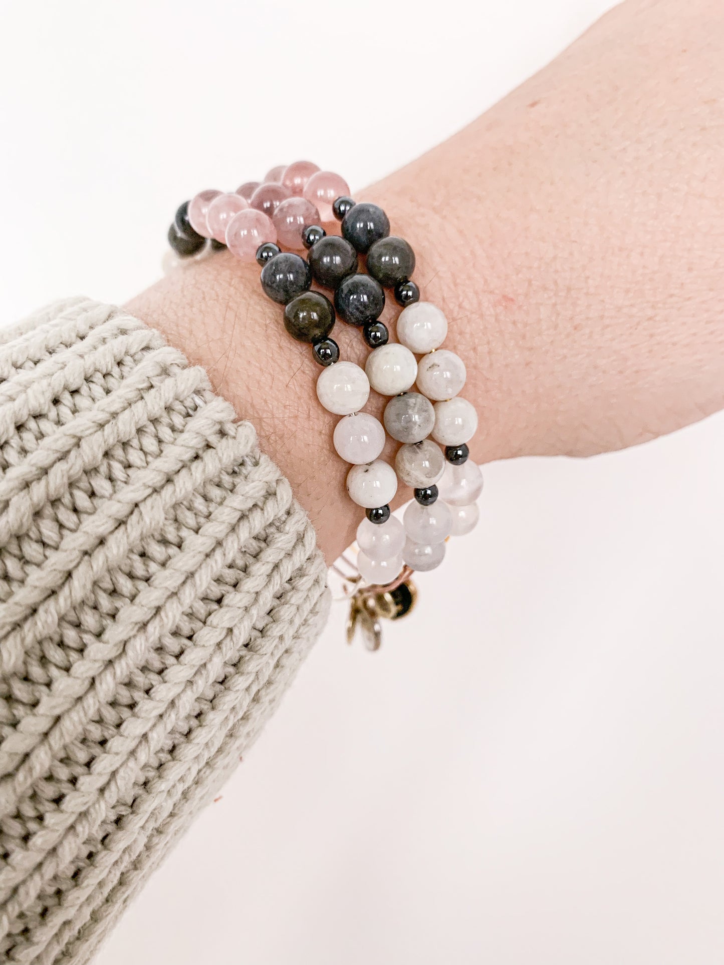 Stack of Cancer Bracelets, illustrating the blend for empowerment and style.