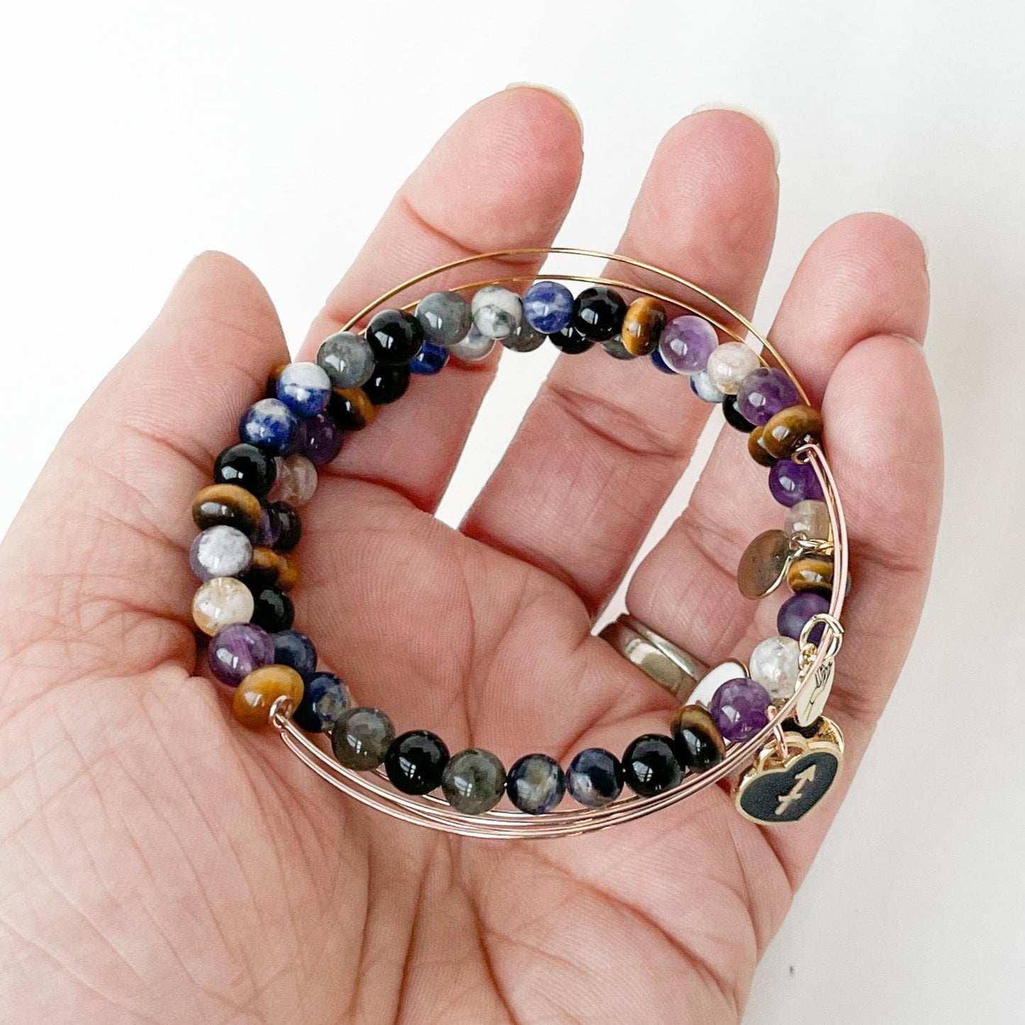 Person holding the Sagittarius Bracelet, representing possibility.