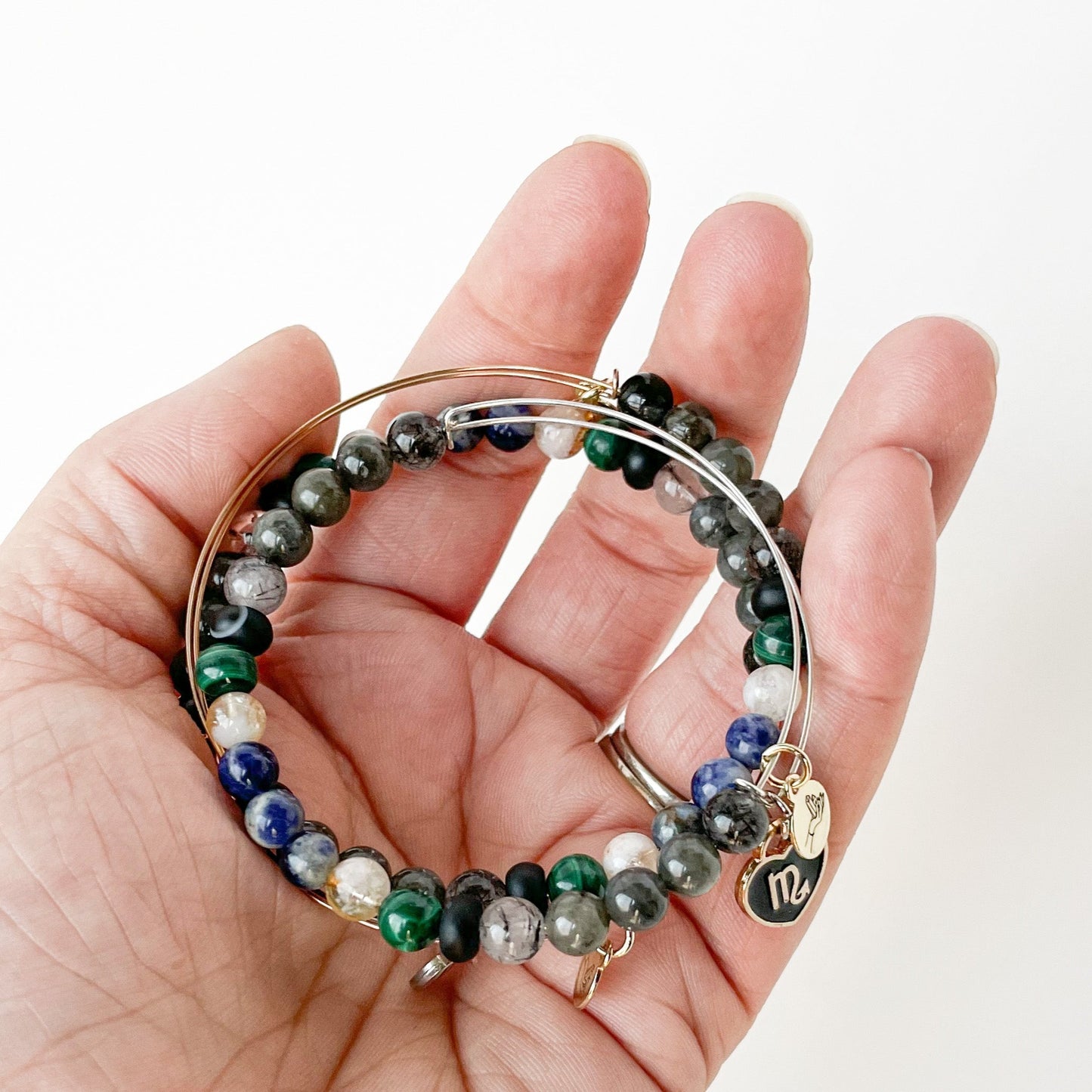 Person holding the Scorpio Bracelet, representing determination.