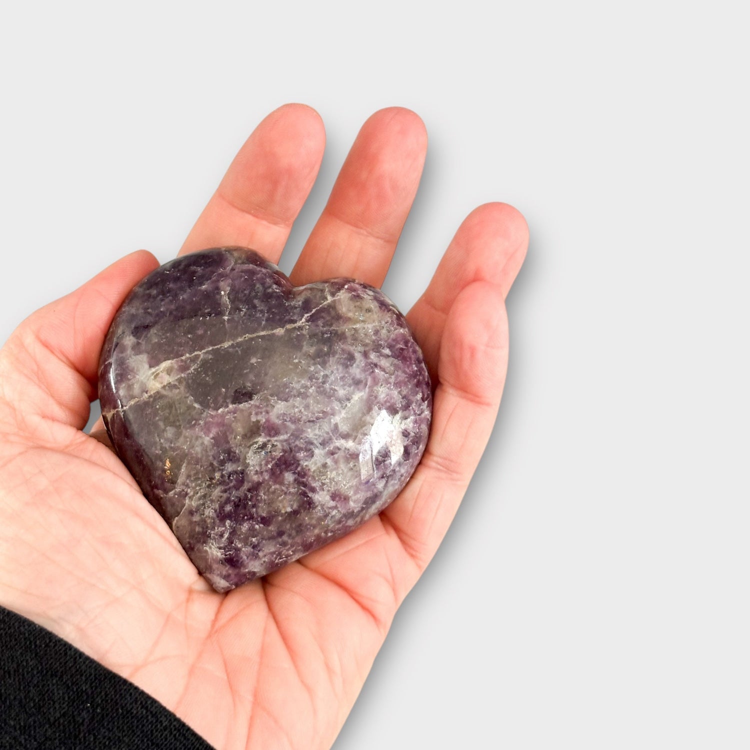 Hand holding Lepidolite Crystal Heart | Rock This Way