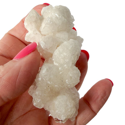 Woman holding a cave calcite/aragonite showing details and size