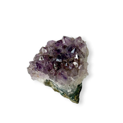 Amethyst crystal cluster on a white background