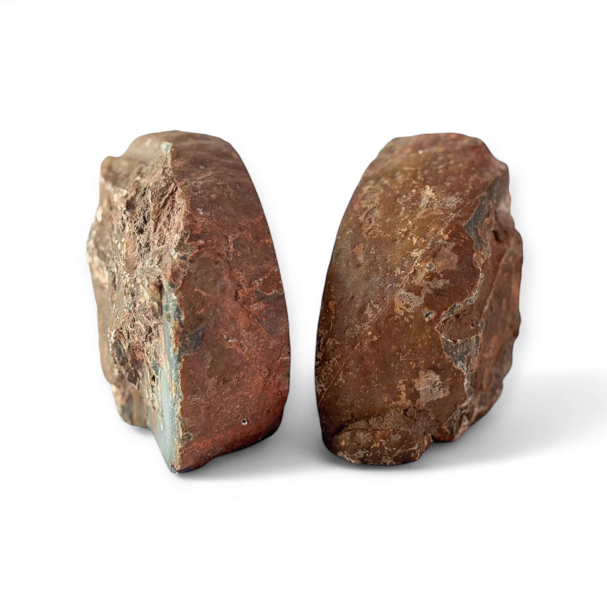 Backside of red and brown agate bookends with raw stone texture