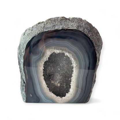 Blue agate geode cluster with polished surface and sparkling druzy center