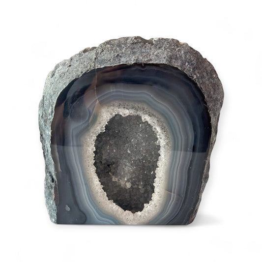 Blue agate geode cluster with polished surface and sparkling druzy center